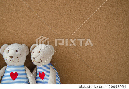 two teddy Bear with Heart on cork board background two teddy Bear with Heart on cork board background 20092064