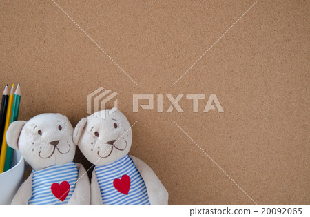 two teddy Bear with Heart on cork board background 20092065