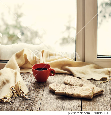 Red cup of coffee or tea, beige scarf  20095081
