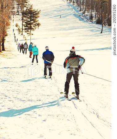 Skiers going uphill on ski lift. 20095260