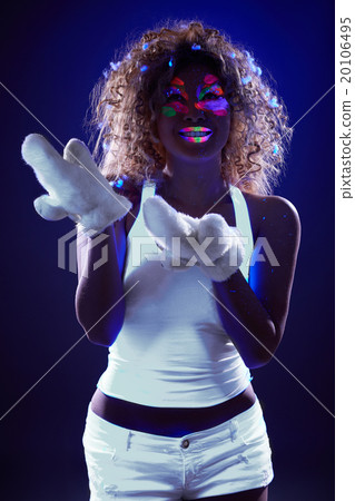 Girl posing with artificial snow under UV light Girl posing with artificial snow under UV light 20106495