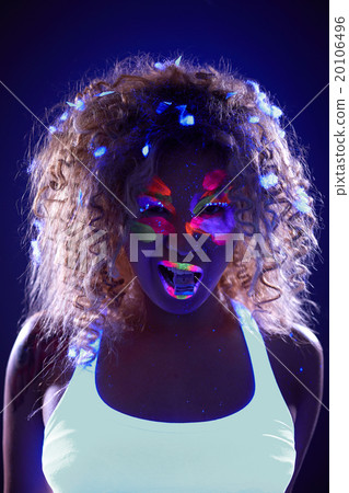 Portrait of pretty girl with candy in neon light 20106496