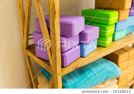 close up of rack with yoga foam blocks and plaids 20108613