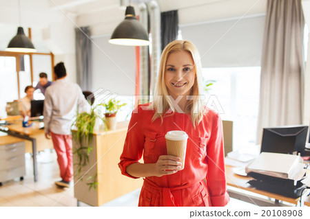 happy creative woman with coffee cup at office 20108908