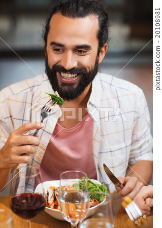 happy man having dinner at restaurant happy man having dinner at restaurant 20108981