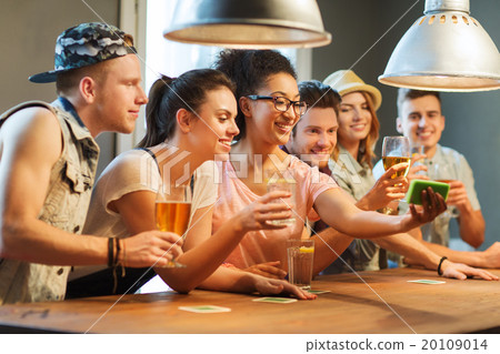 happy friends with smartphone taking selfie at bar 20109014