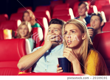 friends watching horror movie in theater 20109191