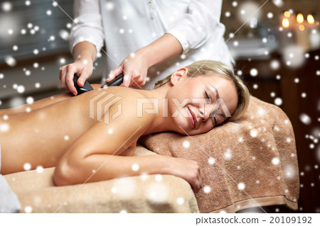 close up of woman having hot stone massage in spa 20109192