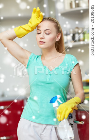 tired woman cleaning home kitchen 20109685