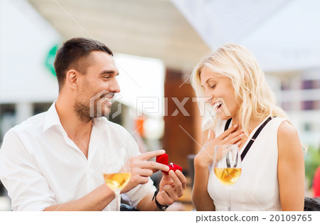 happy couple with engagement ring and wine at cafe happy couple with engagement ring and wine at cafe 20109765