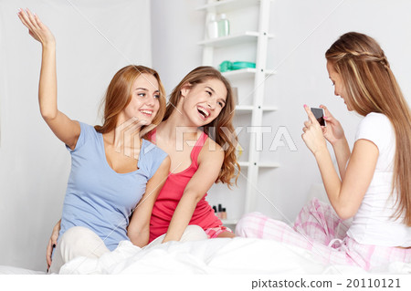 teen girls with smartphone taking picture at home 20110121