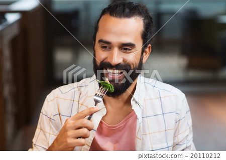 happy man having dinner at restaurant 20110212