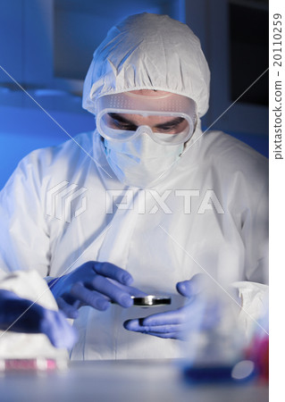 close up of male scientist with test sample in lab 20110259
