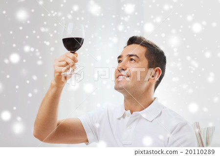 happy man drinking red wine from glass at home 20110289