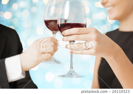 happy engaged couple clinking wine glasses 20110323
