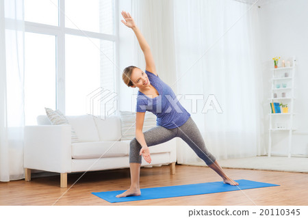 woman making yoga bikram triangle pose on mat 20110345