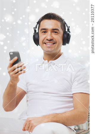 happy man with smartphone and headphones 20110377