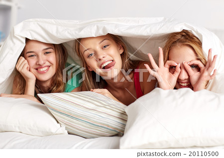 happy young women in bed at home pajama party 20110500