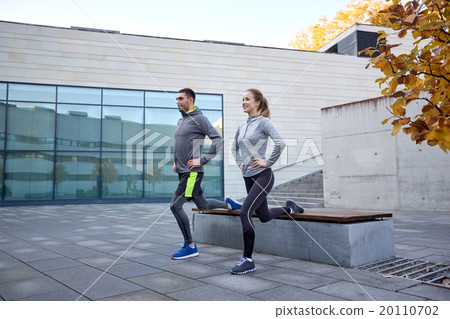 happy man and woman exercising on bench outdoors happy man and woman exercising on bench outdoors 20110702