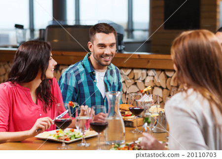 happy friends having dinner at restaurant happy friends having dinner at restaurant 20110703