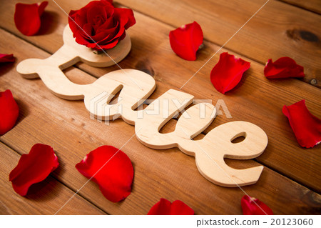 close up of word love cutout with red rose on wood 20123060