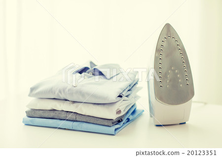 close up of iron and clothes on table at home 20123351