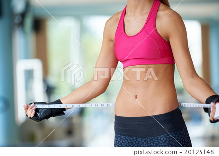 young fit woman measuring belly 20125148