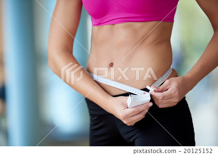 young fit woman measuring belly 20125152