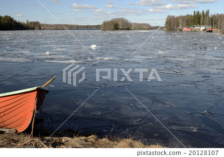 orange rescue boat on the shore of a frozen lake orange rescue boat on the shore of a frozen lake 20128107
