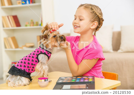 Little girl is caressing her pet.  20128530
