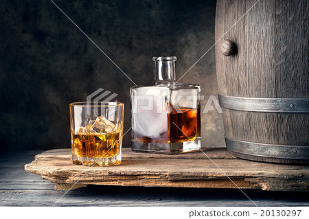 Glass of whiskey with ice decanter and barrel 20130297
