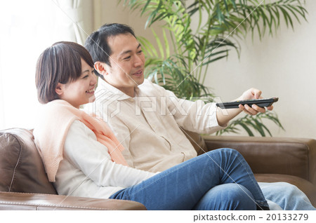A couple looking at television A couple looking at television 20133279