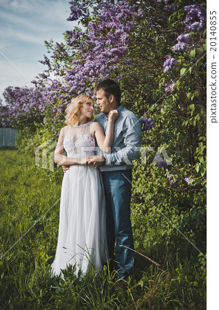 Portraits of a young pair in lilac bushes 3156. Portraits of a young pair in lilac bushes 3156. 20140855