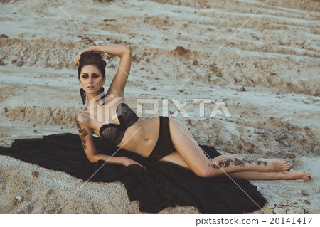 The girl in underwear lies among sand 3439. 20141417