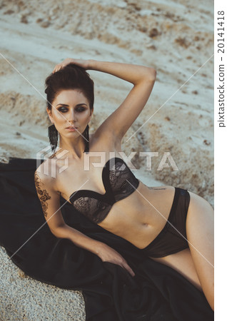 The girl in underwear lies among sand 3440. 20141418