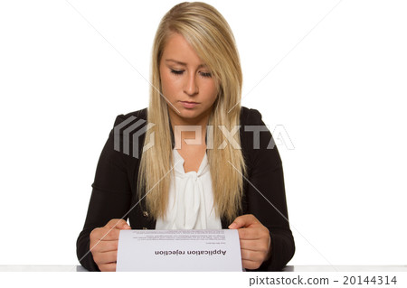 Young woman got a job application rejection a looks astonished Young woman got a job application rejection a looks astonished 20144314