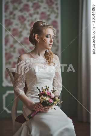 The girl looks towards a window 2725. 20144869