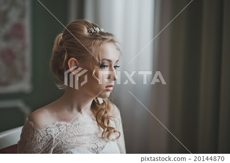 The girl looks towards a window 2728. The girl looks towards a window 2728. 20144870