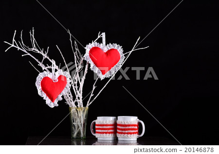 Pair of red hearts on a branch with two mugs 20146878