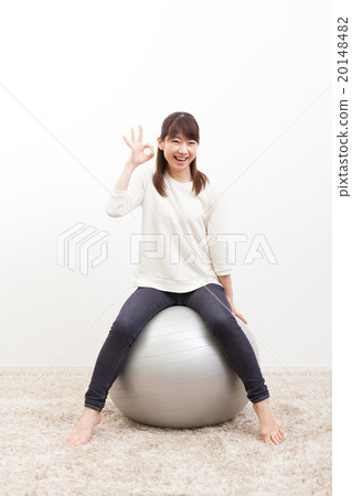 Young lady riding a balance ball Portrait 20148482