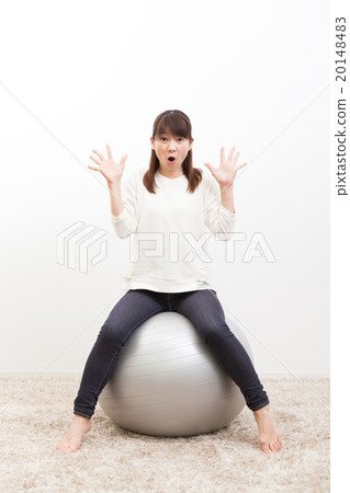 Young lady riding a balance ball Portrait Young lady riding a balance ball Portrait 20148483