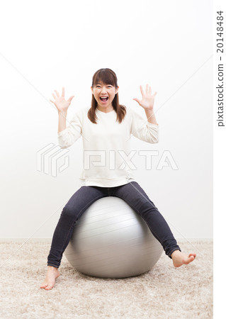 Young lady riding a balance ball Portrait Young lady riding a balance ball Portrait 20148484