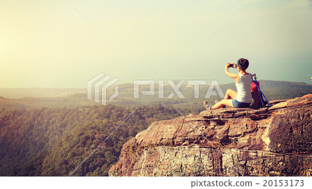 woman hiker use digital tablet on mountain peak woman hiker use digital tablet on mountain peak 20153173