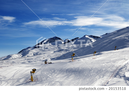 Ski slope with snowmaking at sun morning Ski slope with snowmaking at sun morning 20153518