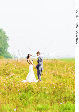 Young happy wedding couple holding hands Young happy wedding couple holding hands 20155369