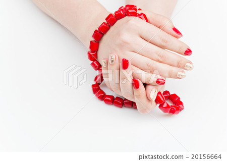 Woman hands with red and gold manicure 20156664