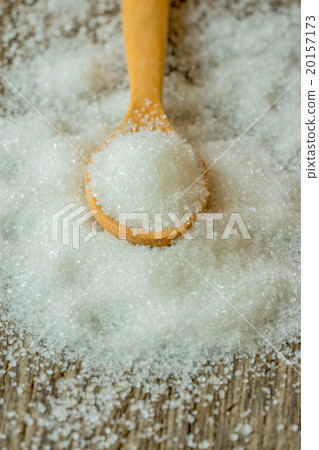 sugar in a wooden spoon on wooden background. 20157173