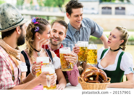 Friends in Bavarian beer garden drinking in summer Friends in Bavarian beer garden drinking in summer 20157901