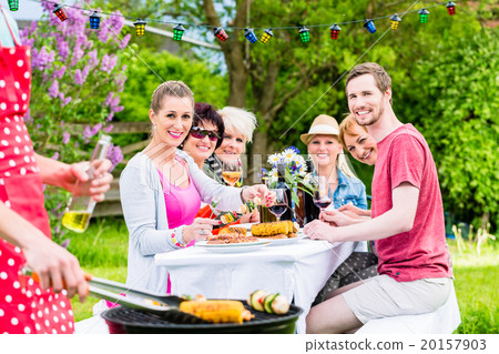 Man grilling meat and vegetables on garden party Man grilling meat and vegetables on garden party 20157903