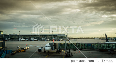 Airplane with passenger boarding bridge at airport gate Airplane with passenger boarding bridge at airport gate 20158000